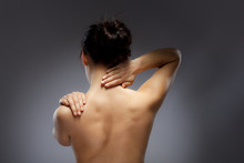 Woman Massaging Pain Back