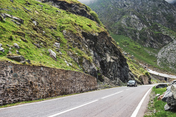 Car drive on the most famous and dangerous road in Europe is a Transfagarasan road in Carpathian mountains, Romania