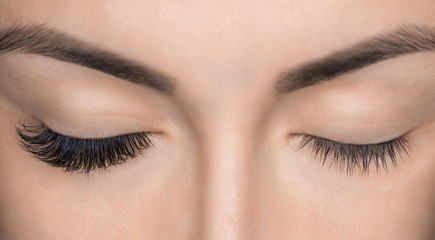 eyelash removal procedure close up. beautiful woman with long lashes in a beauty salon. eyelash exte
