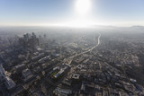 Fototapeta Do pokoju - Hazy summer afternoon aerial view of urban downtown Los Angeles streets and towers. 