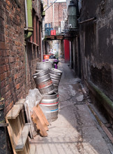 Empty Beer Kegs Awaiting Collection In A Narrow Back Alley Behind Licensed Premises In Manchester City Centre.