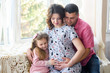 © Nestyda - Happy pregnant family with little girl having fun at home