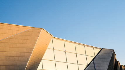 Element of the facade of a modern building against a blue clear sky. Empty space for text background. Abstract Architecture Background