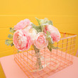 artificial flowers on pink table