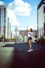 Wall Mural - portrait attractive women in sports white T-shirt Posing on football field