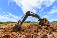 Excavator Digging To Moving The Soil To The Truck And Adjusting Ground Level In Construction Site.