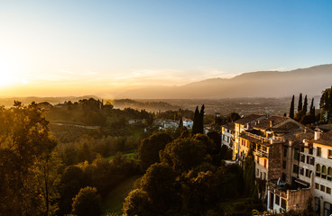 view of old italian town Asolo at sunset from hill with ancient buildings