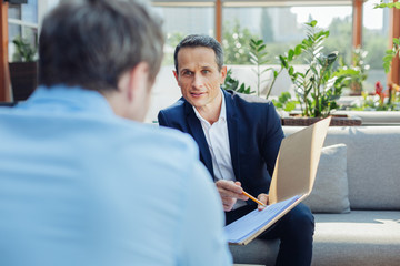 Wall Mural - Pleasant handsome businessman looking at his business partner