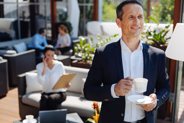 Cheerful delighted man being in a good mood