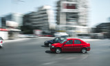 Fototapeta Koty - Red car in motion