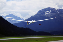 A Glider Is Flying In The Alps