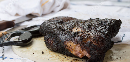 Cuadros en Lienzo A close up of a large slab of cooked meat at an outdoors barbecue