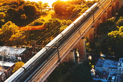 Aerial view of the of a train crossing the Hell Gate Bridge over the East River Poster