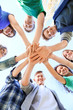 © Africa Studio - Young people putting hands together outdoors. Volunteer concept