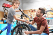 © Africa Studio - Dad and son fixing bicycles in garage