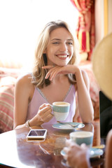 Poster - Beautiful young women drinking coffee in cafe