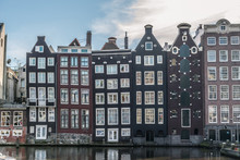 Amsterdam, The Netherlands, Europe. Traditional Old Buildings Reflected In The Canal.