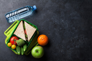 Lunch box with vegetables and sandwich