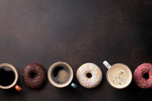 Coffee Cups And Colorful Donuts