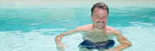 Handsome Middle Aged Man In Sunny Swimming Pool On Vacation