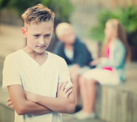 Upset boy after quarrel with playmates