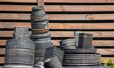 Empty plastic containers from plants stacked to the pile