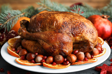 Canvas Print - Plate with tasty whole roasted turkey on table