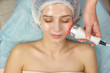 Radio frequency skin tightening device. Girl wearing hydrogel mask. Modern methods of skin treatment.