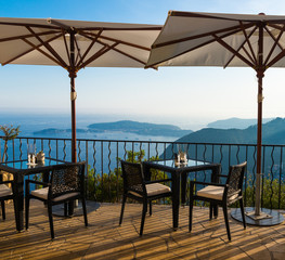 Empty dining table with stunning views overlooking the French Riveira on a sunny day