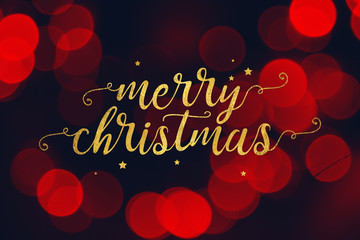 Wall Mural - gold merry christmas script and stars with red bokeh lights background
