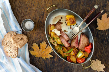 Wall Mural - Roast beef steak with fried vegetables in pan