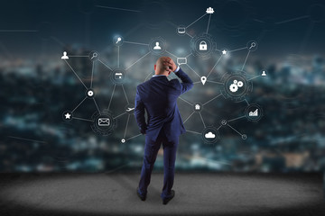 Poster - businessman in front of a wall with a business network connection displayed on a futuristic interfac