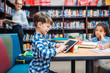 © LIGHTFIELD STUDIOS - schoolboy using tablet at library