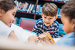 © LIGHTFIELD STUDIOS - kids reading books in library