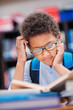 © LIGHTFIELD STUDIOS - schoolboy reading book in library