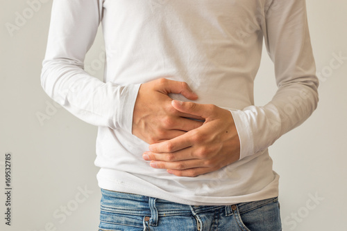 Cuadros en Lienzo Young man suffering from stomach ache, diarrhea, constipation, acid reflux, indi