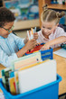 © LIGHTFIELD STUDIOS - kids choosing supplies in box