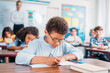 © LIGHTFIELD STUDIOS - schoolboy writing in notebook