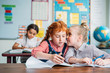 © LIGHTFIELD STUDIOS - little girls gossiping in class
