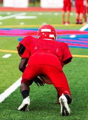 Wall Mural - Football player in three point stance at practice