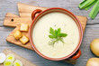leek and potato soup on wooden cutting board