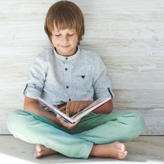 Wall Mural - A child with a book 