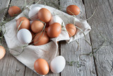 Fototapeta Mapy - Fresh chicken brown eggs on rustic wood, organic farming concept