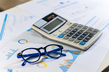 Close Up Business Concept, Calculator And Glasses On Summary Report On Table Office