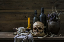 Human Skull And Pile Bone With Candle Light, Still Life Style On  Wooden Table