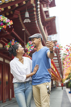 Couple Taking A Selfie In Chinatown