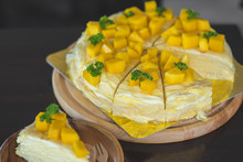 Close Up Mango Crepe With Fresh Mango, Creamy Mango Mousse Cake On A White Wood Background. Toning. Selective Focus, Mango Cheesecake On White Plate With Fork