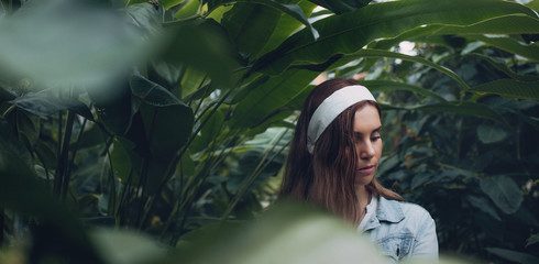 Beautiful female gardener in greenhouse