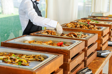 Outdoor Cuisine Culinary Buffet Dinner Catering. Group of people in all you can eat. Dining Food Celebration Party Concept. Service at business meeting, weddings. Selective focus.