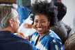 © Trinette Reed/Stocksy - African American woman with group of friends and family having a cocktail party in their home